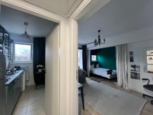 a living room with a kitchen and a bedroom at Cosy studio Floreasca in Bucharest