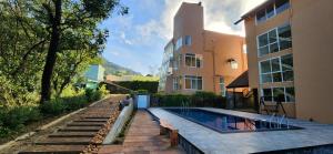 a house with a swimming pool next to a building at Mount Hunt Resort Beragala Haputale in Beragala