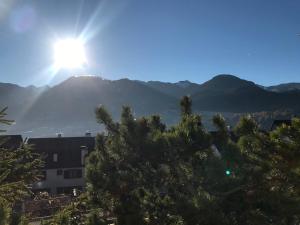 a view of a mountain with the sun in the sky at Suite Marco nice apartment in Cavalese with View in Cavalese
