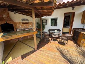 an outdoor patio with a table and chairs at Serena Suíte Lumiar in Lumiar