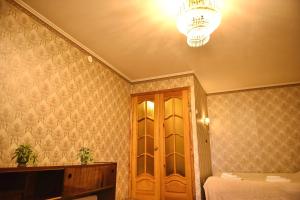 a room with a bed and a chandelier at Недорога квартира на Харківській, 32 in Sumy