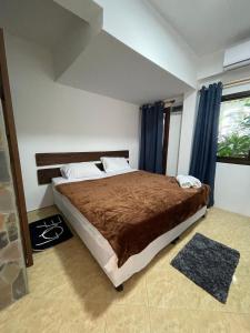 a bedroom with a large bed with blue curtains at Villa Aisawan in Phuket +31 photos