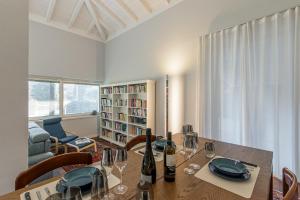 a dining room with a table with wine glasses at Villa Ceratti in Cassano Magnago