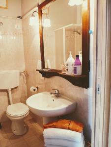 a bathroom with a sink and a toilet and a mirror at B&B Franciacorta in Castrezatto +32 photos