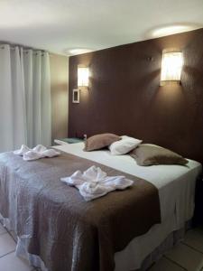 two beds in a hotel room with towels on the bed at Hotel Pousada Cumbuco Gold in Cumbuco +34 photos