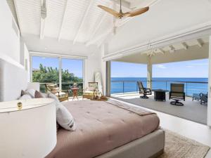 a bedroom with a large bed and a view of the ocean at This place was great to accommodate everyone in Koolbaai