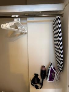 a closet with two ties and a coffee maker at Chelsea Studio South Kensington 10 Min to Harrods in London +4 photos