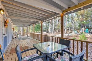 a screened porch with a table and chairs on it at Secluded Hamilton Cabin Retreat with Private Lake! in Hamilton
