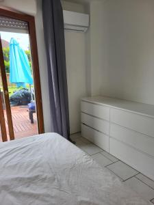 ein Schlafzimmer mit einem Bett, einer Kommode und einem Regenschirm in der Unterkunft Grande maison jusqu'à 9 pers in Ézy-sur-Eure