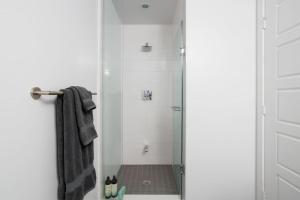 a bathroom with a shower with a glass door at Amazing 2BR 2BA Resort Condo w Balcony and Parking in Barrie +34 photos