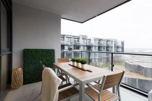 a dining room with a table and chairs on a balcony at Amazing 2BR 2BA Resort Condo w Balcony and Parking in Barrie