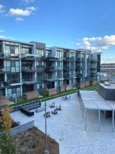a large apartment building with a picnic table and benches at Amazing 2BR 2BA Resort Condo w Balcony and Parking in Barrie
