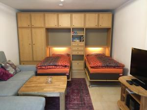 a living room with two beds and a couch at Ferienwohnung Klausgraben in Bischofswiesen