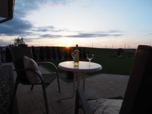 a table with a bottle of wine and a glass at Panorama in Ravensberg