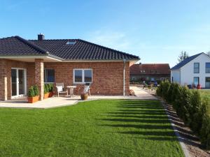 a brick house with a green lawn at Panorama in Ravensberg