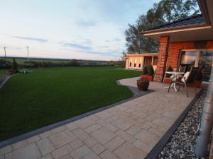 a backyard with a patio and a lawn at Panorama in Ravensberg