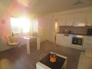 a living room with a table and a kitchen at Panorama in Ravensberg +55 photos