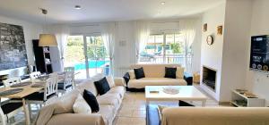 a living room with a couch and a table at Casa con piscina en costa Barcelona in Sant Vicenç de Montalt