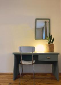 a desk with a chair and a mirror at CasaCampo Affittacamere in Campogalliano
