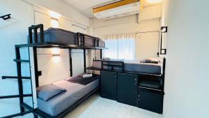two bunk beds in a room with a window at Stay At Moon Hostel Haad Rin in Haad Rin