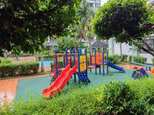 a playground with a slide in a park at Urban Oasis Apartment 6 in Melaka
