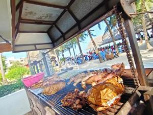 a bunch of chickens on a grill on a table at The New Big Tree Beach Resort in Mombasa