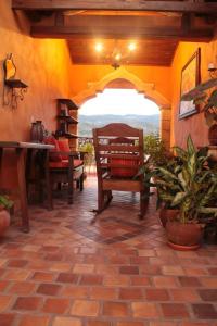 a patio with a table and benches and a table and chairs at Plaza Yat B'alam in Copan Ruinas