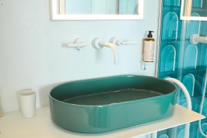 a blue tub sitting on a counter in a bathroom at CALEA Boutique Hotel in Bacoli