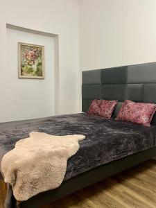 a bedroom with a large bed with red pillows at Stylish Stay in Ēveles Street in Rīga