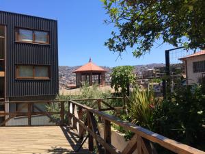 a house with a wooden walkway and a gazebo at Casona Artilleria in Valparaíso