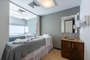 Postel nebo postele na pokoji v ubytování Hotel Estelar Milla De Oro