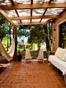 a patio with two hammocks and a pergola at Casa Bambú - Brisas del Lago in Puerto Bossetti
