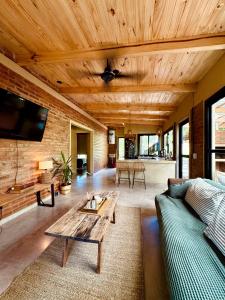 a living room with a couch and a table at Casa Bambú - Brisas del Lago in Puerto Bossetti
