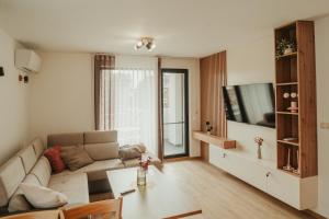 a living room with a couch and a table at Apartment Aria 2 in Velingrad