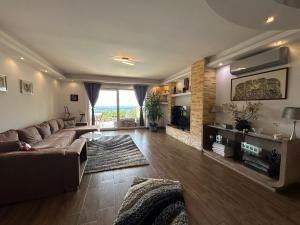a large living room with a couch and a fireplace at Villa Somlyó in Fót