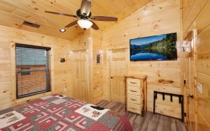 a bedroom with a bed and a ceiling fan at A Splash of Heaven in Pigeon Forge +70 photos
