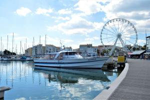 a boat is docked in a marina with a ferris wheel at Studio CAP D'AGDE CT121-019 in Cap d'Agde