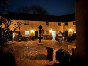 a large brick building with a courtyard at night at Gezellige cottage bij Valkenburg in Voerendaal