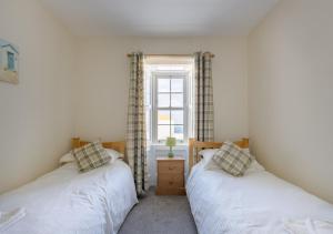 two twin beds in a room with a window at 3 Bed in Drummore oc-k30214 in Drummore