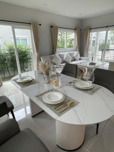 un soggiorno con tavolo e sedie bianchi di Ruby House a Ban Pa Khlok