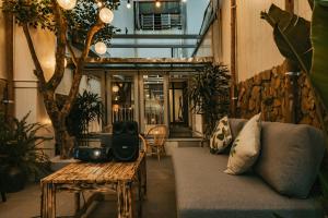 a living room with a couch and a table at Bong House close to train street at the Hanoi old quarter in Hanoi
