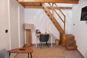 a room with a desk and a table with a chair at Chiaia 100 rooms in Naples