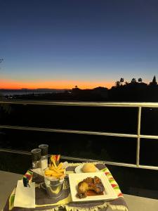 a table with a plate of food and french fries at Marbella Boutique Art suites in Marbella