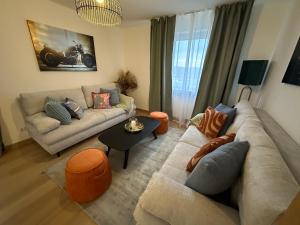 a living room with a couch and a table at ARGENTA Living 129 in Künzell