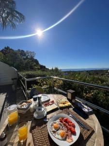 a table with a plate of food on a balcony at Marbella Boutique Art suites in Marbella