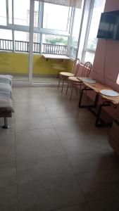 Zimmer mit Tischen, Stühlen und Fenstern in der Unterkunft Departamento céntrico temuco in Temuco