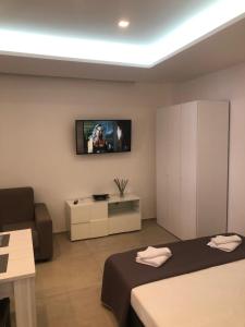 a bedroom with a bed and a tv on the wall at Ciuri Ciuri in Castellammare del Golfo +12 photos