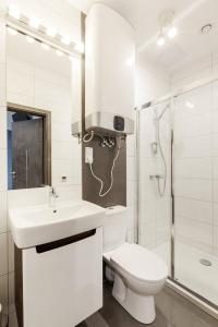 a bathroom with a toilet and a sink and a shower at Pokoje Cinema in Poznań
