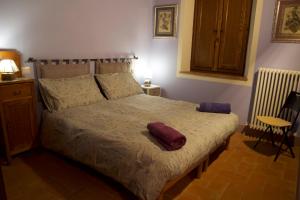 a bedroom with a large bed with two pillows on it at Valdorcia in San Quirico dʼOrcia