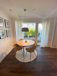a dining room with a table and chairs and a window at CityLoft Andernach in Andernach +7 photos